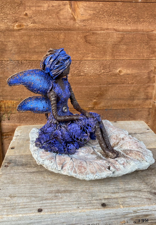 Fairy on cement leave